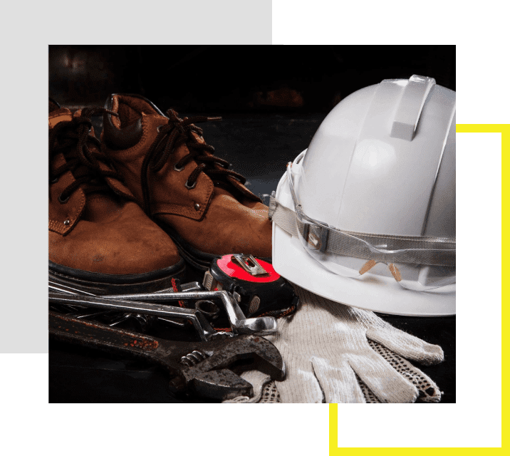 A pair of shoes and a hard hat on top of a table.